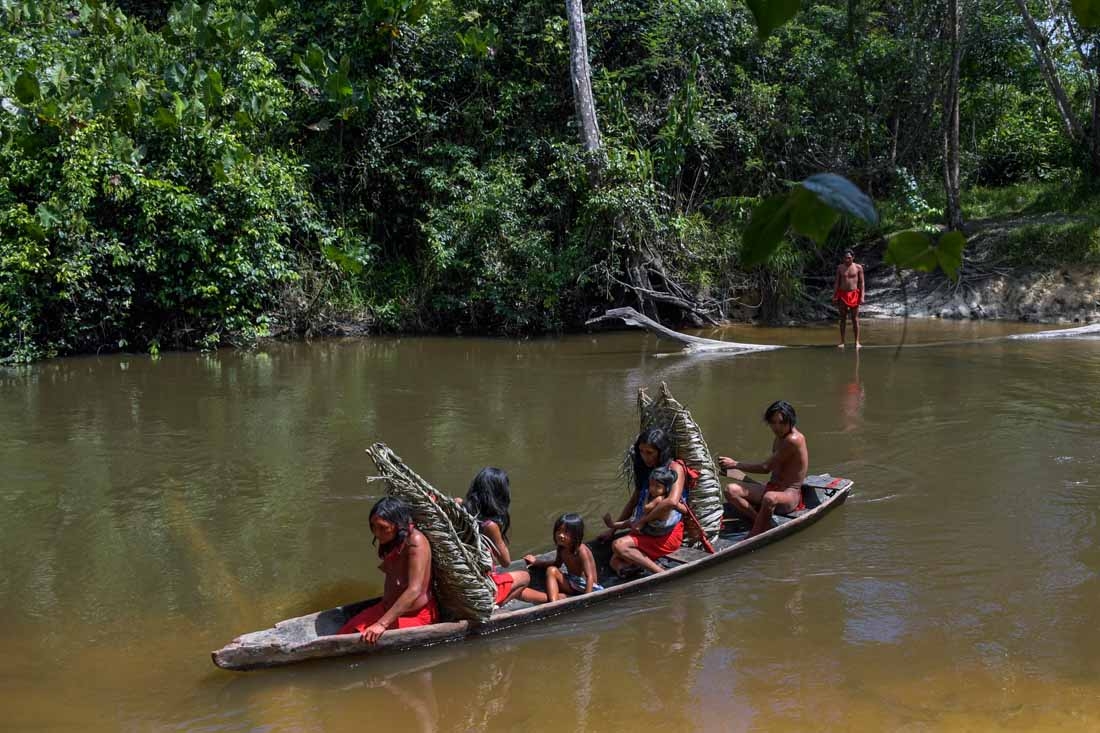 Waiapi people cross the Feliz river by barge, to go to harvest manioc to prepare Caxiri, a craft beer made with Manioc, imbibed daily by men, women and children when is not yet sour yet, at the Waiapi indigenous reserve in Amapa state in Brazil on October