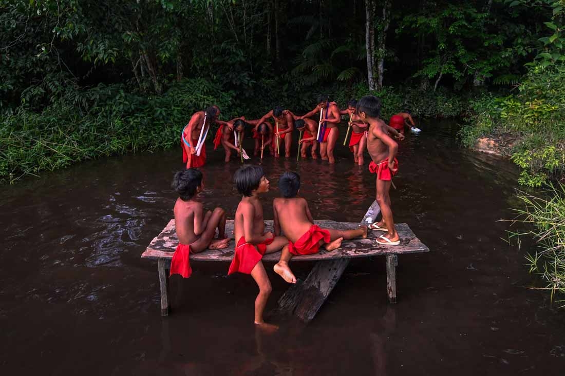 Waiapi men dance and play flute during the Anaconda's party -during which they make flutes to play and dance, and at the end leave all flutes on the river for the Anaconda snake to protect their village- in the Waiapi indigenous reserve in Amapa state in