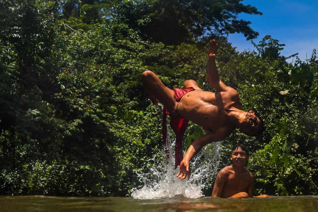 Waiapi men enjoy the Feliz river in the Waiapi indigenous reserve in Amapa state in Brazil on October 14, 2017. The tiny Waiapi tribe is resisting moves by the Brazilian government to open the region of pristine rainforest known as Renca, National Copper