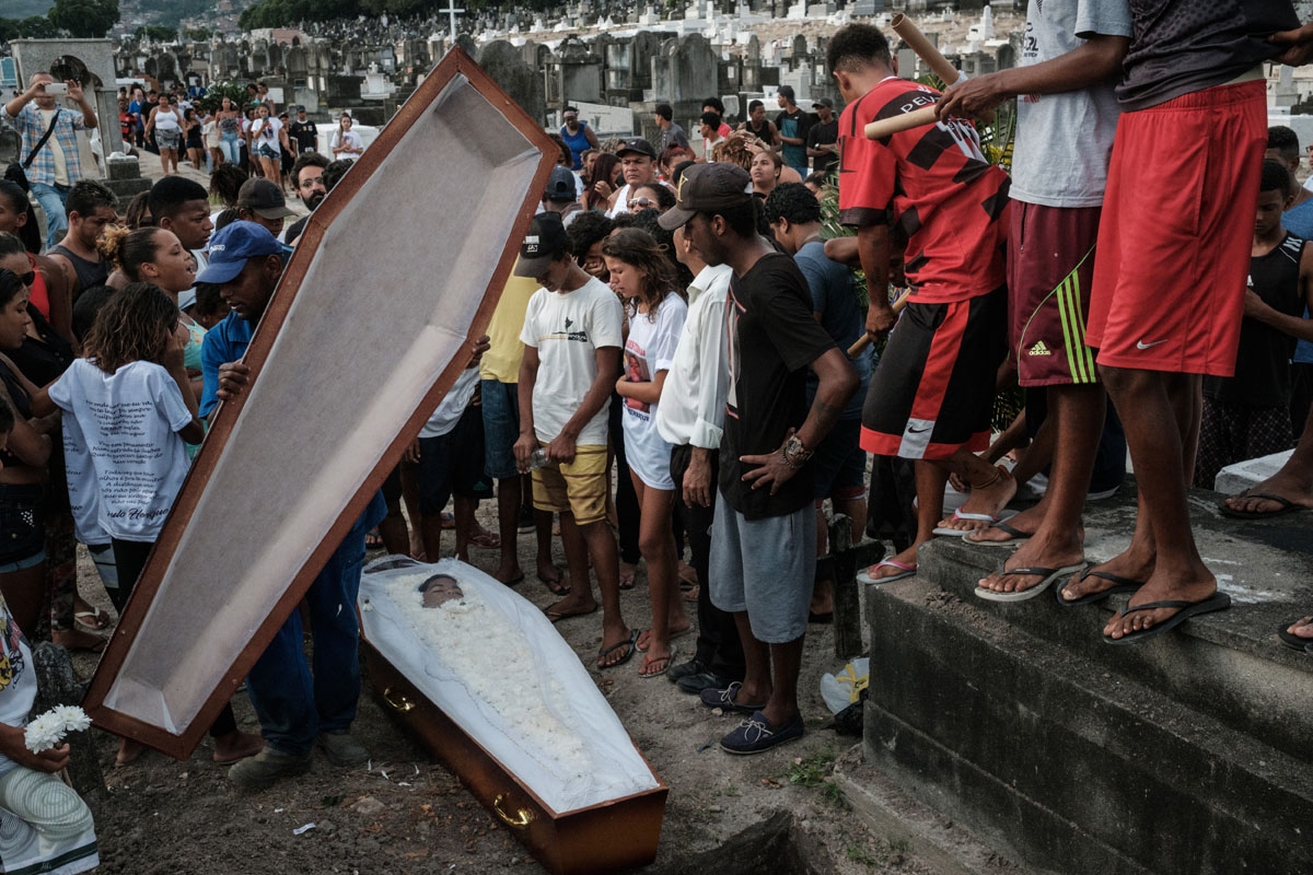 Family members and friends attend the funeral of 13-year-old Paulo Henrique de Oliveira, who was killed by a stray bullet during a police operation against drug dealers in the Complexo do Alemao favela or shantytown in Rio de Janeiro, Brazil, on April 26,