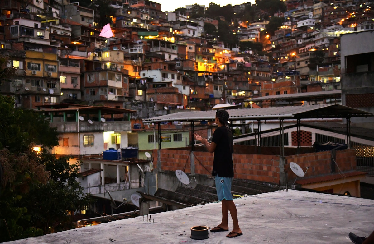 A youngster flies a kite at the Vidigal favela in Rio de Janeiro, Brazil on May 18, 2018.