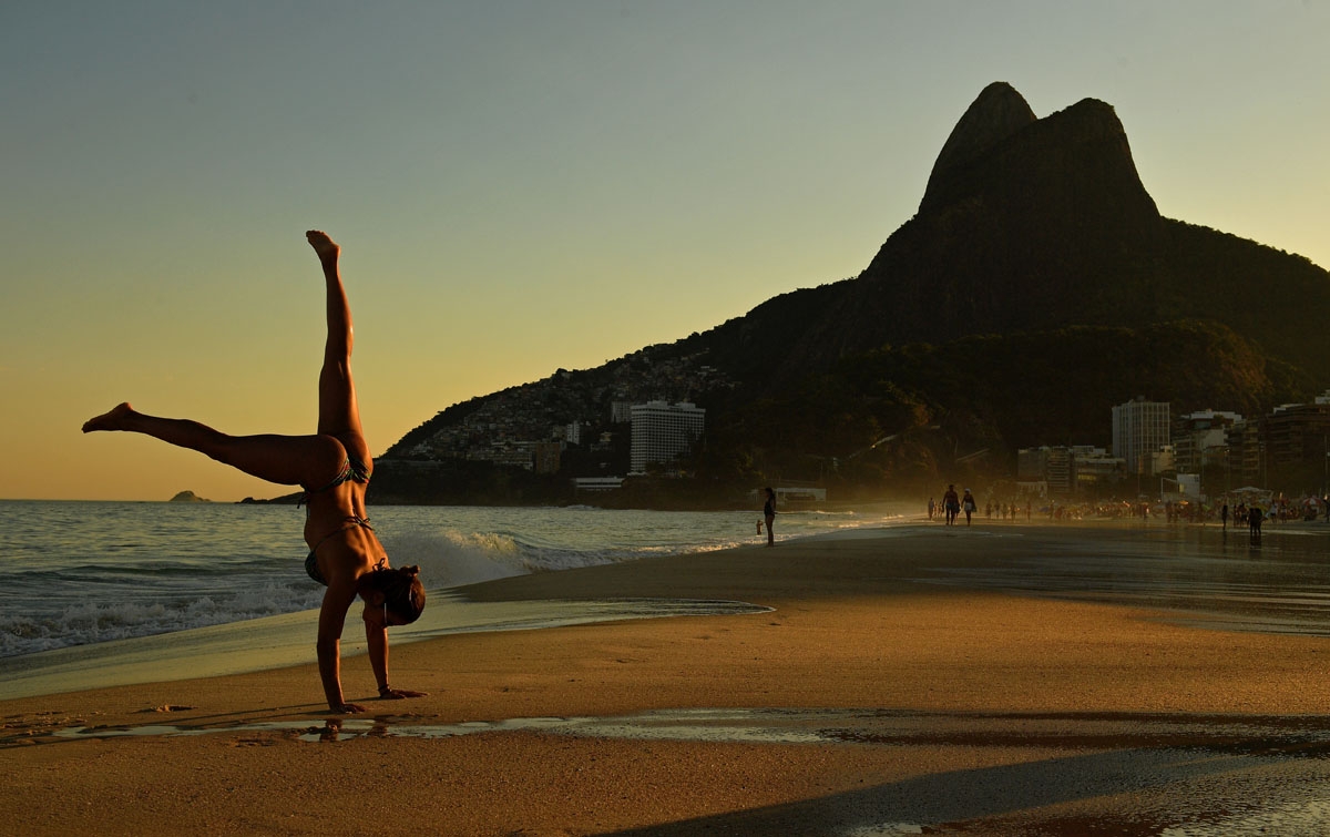 Brazilian gymnast Virginia Lins does a handstand on Ipanema Beach in Rio de Janeiro, Brazil, on June 1, 2018.