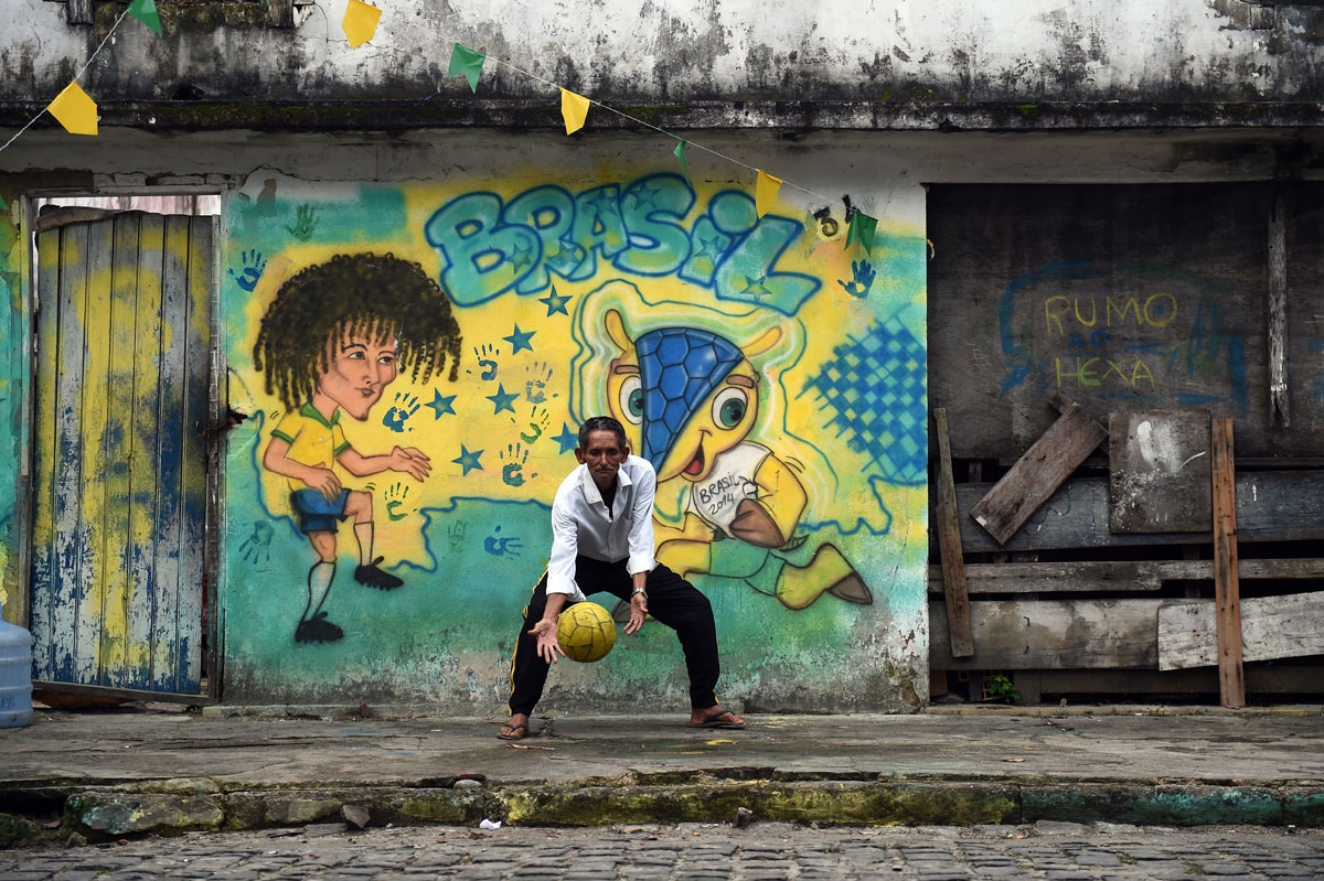 A Brazilian man plays football in Porto Seguro on June 28, 2014, during the Brazil-hosted 2014 FIFA World Cup.
