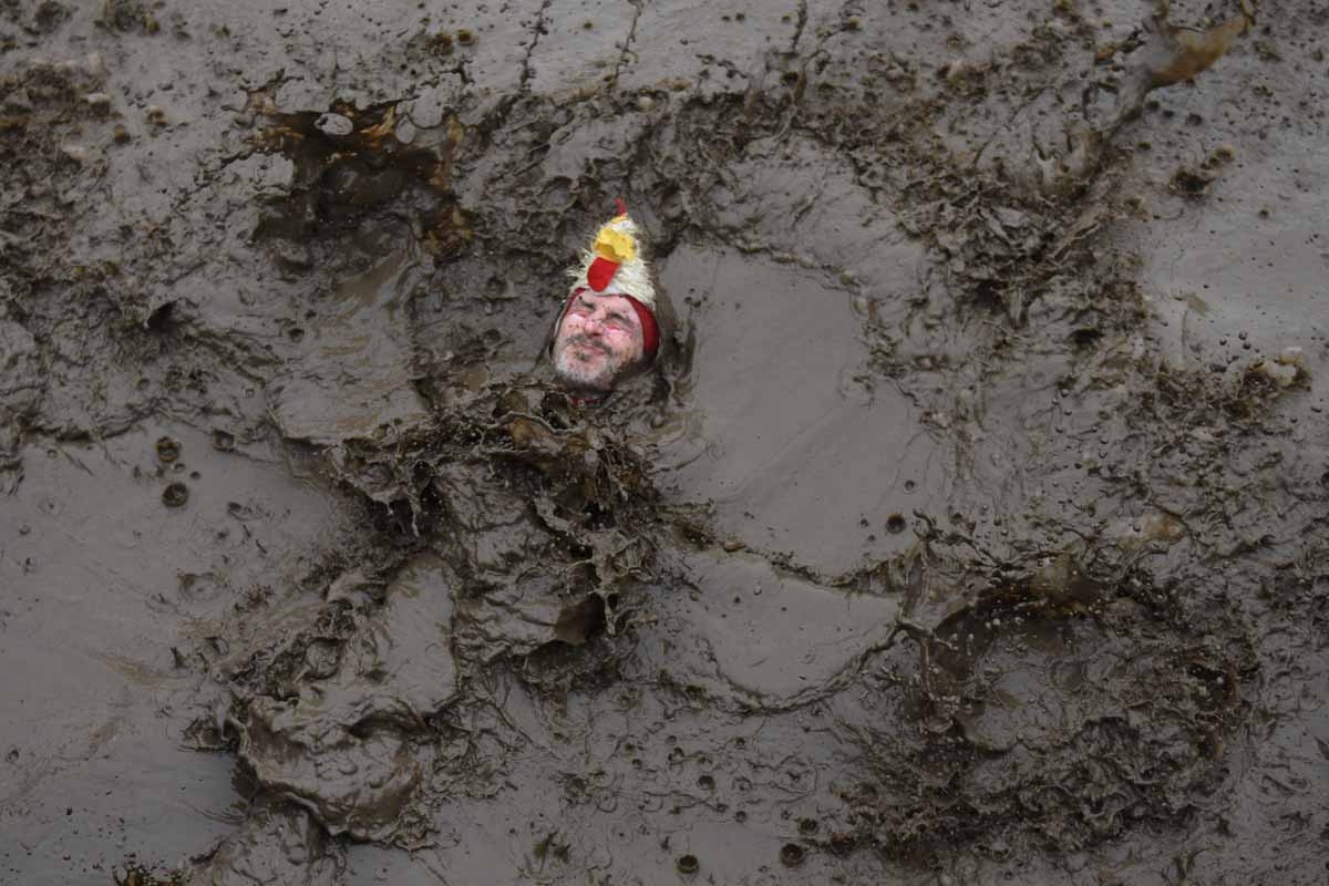 A competitor goes into a muddy pool as he takes part in the 'Tough Guy' adventure race near Wolverhampton, central England, on January 29, 2017. The Tough Guy event, which is being held for the final time in its 30th year, challenges thousands of competi