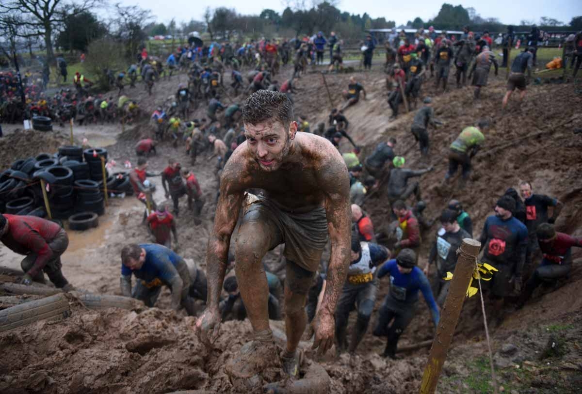 Competitors take part in the 'Tough Guy' adventure race near Wolverhampton, central England, on January 29, 2017. The Tough Guy event, which is being held for the final time in its 30th year, challenges thousands of competitors to run a gruelling course