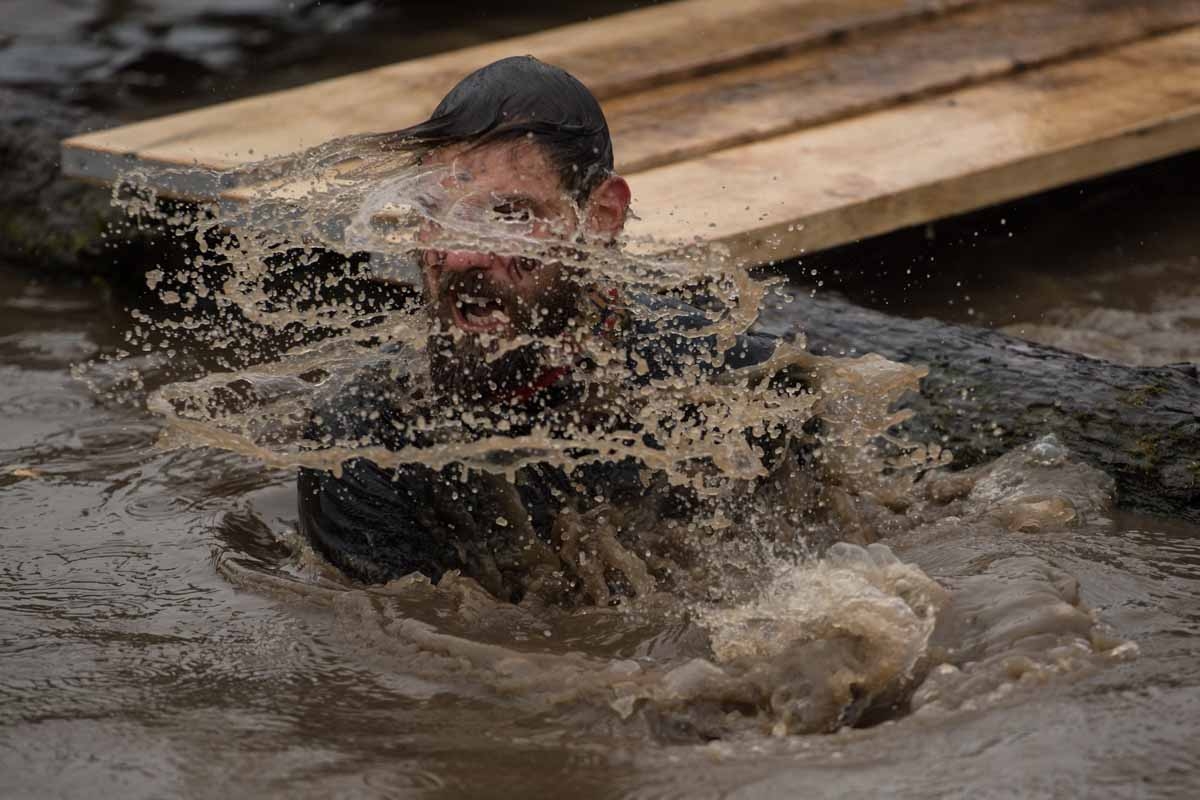 A competitor takes on a water obstacle as he takes part part in the 'Tough Guy' adventure race near Wolverhampton, central England, on January 29, 2017. The Tough Guy event, which is being held for the final time in its 30th year, challenges thousands of