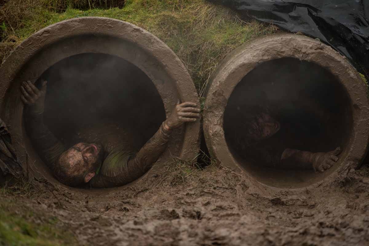 Competitors slide through pipes as they take part in the 'Tough Guy' adventure race near Wolverhampton, central England, on January 29, 2017. The Tough Guy event, which is being held for the final time in its 30th year, challenges thousands of competitor