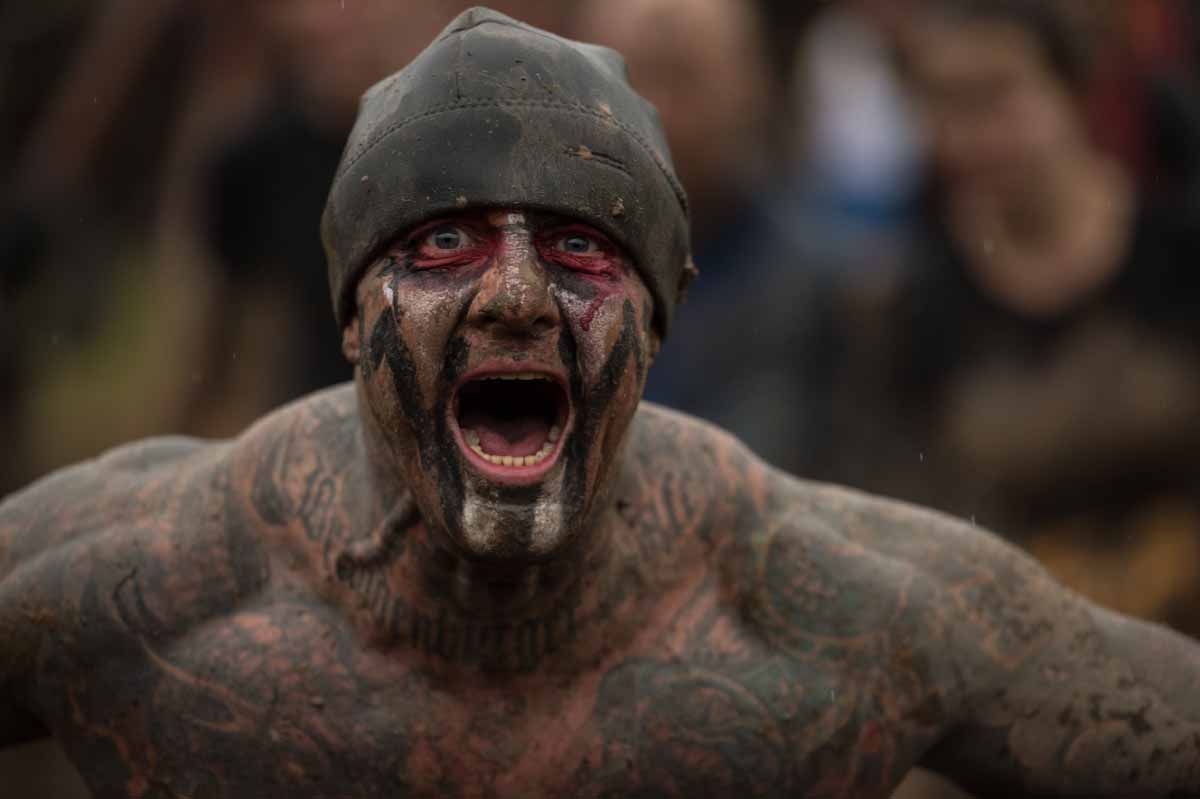 A competitor shouts as he takes part in the 'Tough Guy' adventure race near Wolverhampton, central England, on January 29, 2017. The Tough Guy event, which is being held for the final time in its 30th year, challenges thousands of competitors to run a gr