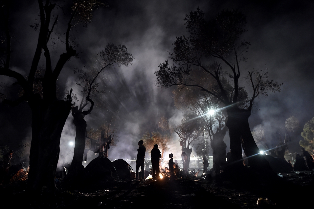 Refugees and migrants spend the night in a field outside of the Moria Hot Spot, on the Greek island of Lesbos on November 9, 2015. More than 3,000 refugees and migrants have drowned among the nearly 800,000 who have reached Europe this year. However, EU s