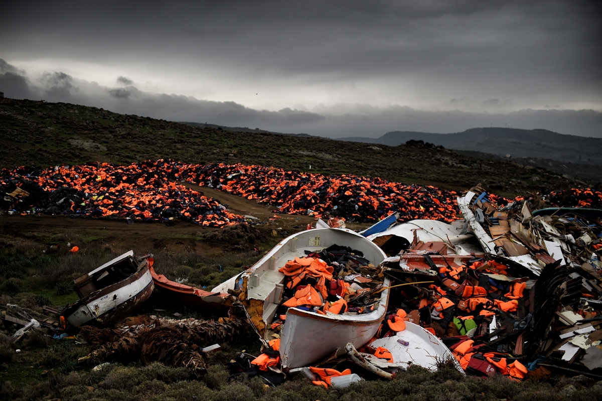 Wrecked boats and thousands of life jackets used by refugees and migrants during their journey across the Aegean sea lie in a dump in Mithimna on February 19, 2016. The EU and Turkey will hold a special summit in early March to push forward a deal to stem