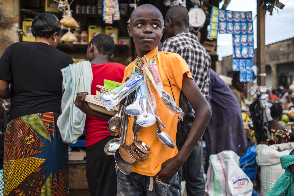 A boy sells kitchen ware at a market in Beni on November 9, 2016.