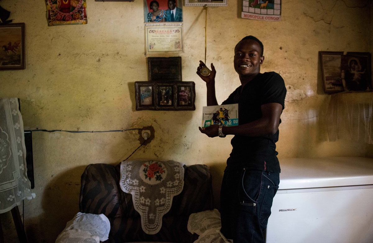 This photograph taken on May 15, 2017, shows Prince Kasongo, a member of the Katumbi Football Academy, showing his awards at his house in Lubumbashi, DR Congo.