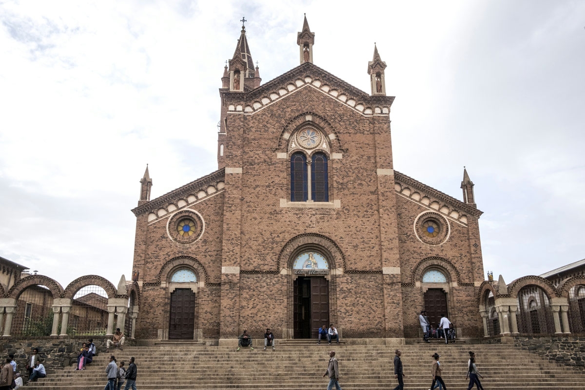 People walk past the catholic Church of our Lady of the Rosary in the Eritrean capital of Asmara, on July 21, 2018.