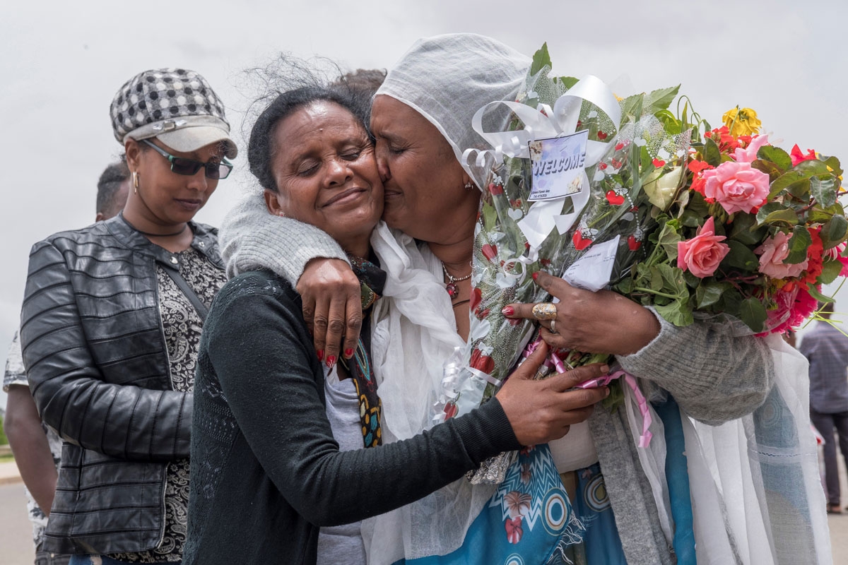 Fana Tesfatsion (R) hugs her sister Alem as the siblings see each other for the first time in five years at Asmara airport on July 21, 2018. since five years at Asmara International airport on July 21, 2018.