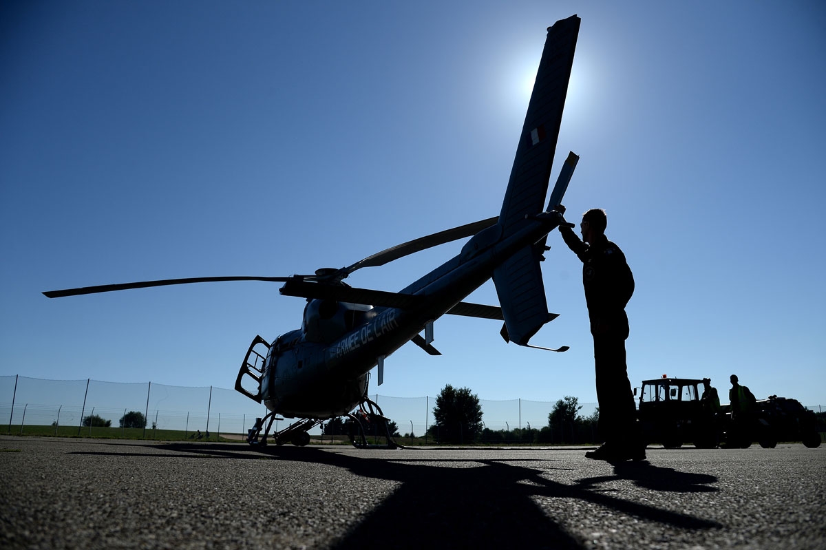 A pilot prepares his Eurocopter Fennec helicopter of the French Air Force, prior to the annual Bastille Day military parade on the Champs-Elysees avenue in Paris on July 14, 2017.
