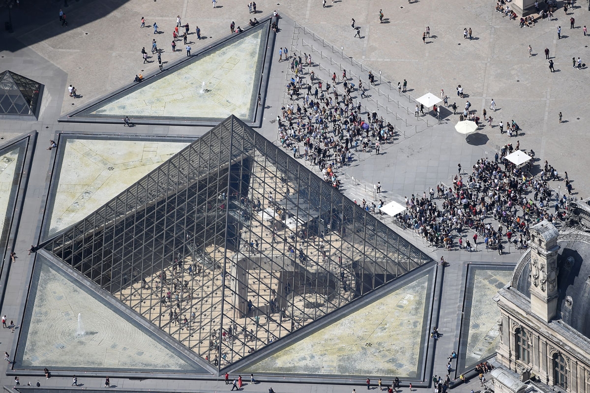 A picture taken on July 14, 2017, in Paris, shows an aerial view of the Louvre Pyramid located in the main courtyard, the Cour Napoleon, of the Louvre Palace and that serves as the main entrance to the Louvre Museum.