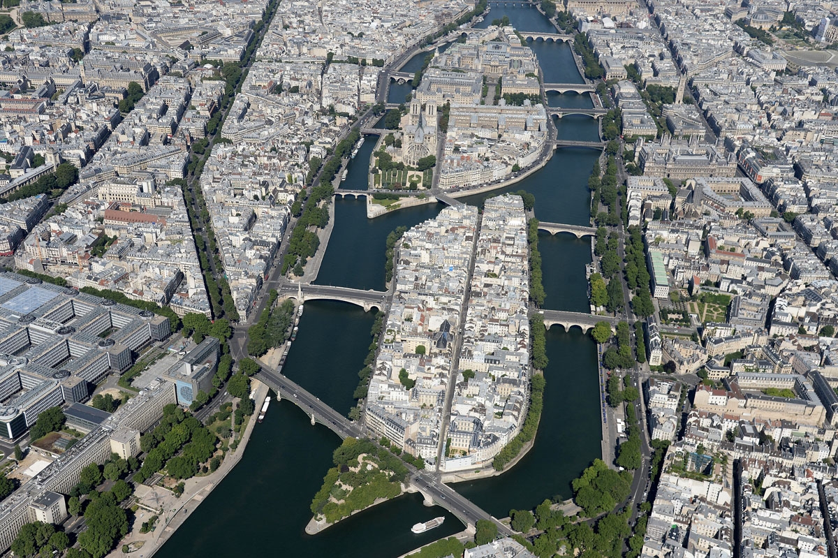 A picture taken on July 14, 2017, in Paris, shows an aerial view of the river Seine and of the Ile Saint Louis and Ile de la Cite with the Notre-Dame Cathedral. /