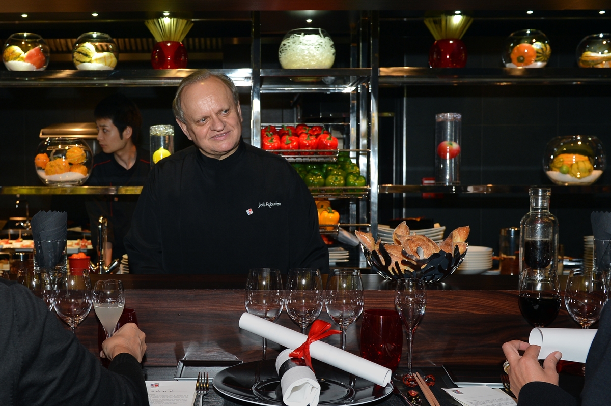Joel Robuchon talks to customers at his Atelier restaurant in Paris, November, 2012.