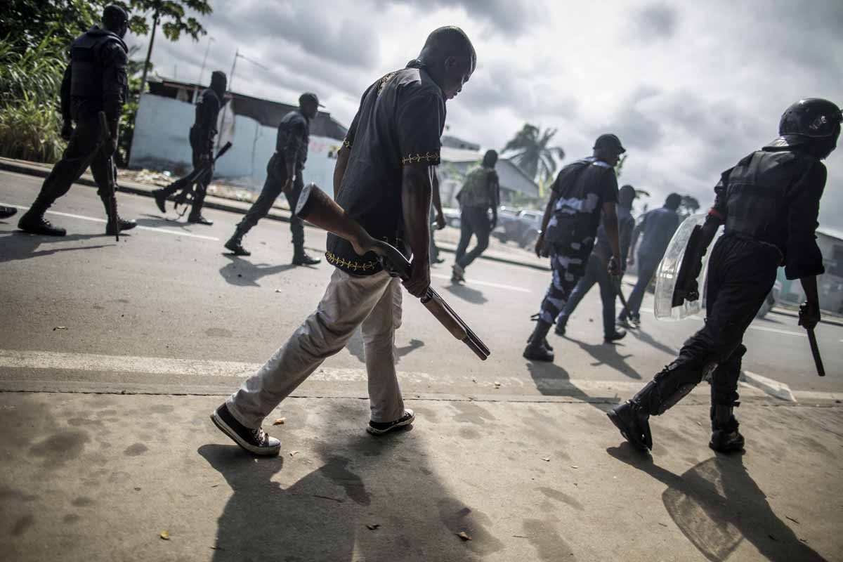 Gabonese police forces patrol as they clear barricades in the streets adjacent to the National Assembly, in Libreville, on September 1, 2016.