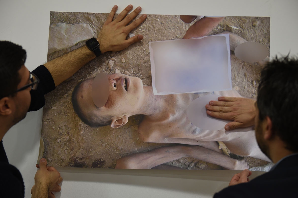 Members of the Syrian Organisation for the Victims of War (SOVW) display pictures documenting the torture of detainees inside the Assad regimeâs prisons and detention centres, on March 17, 2016 in Geneva. The photographs were taken by a former military 