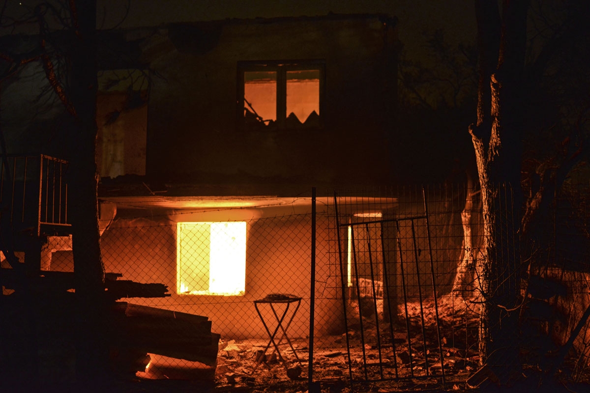 A house burns during a wildfire at the village of Mati, near Athens on July 23, 2018.