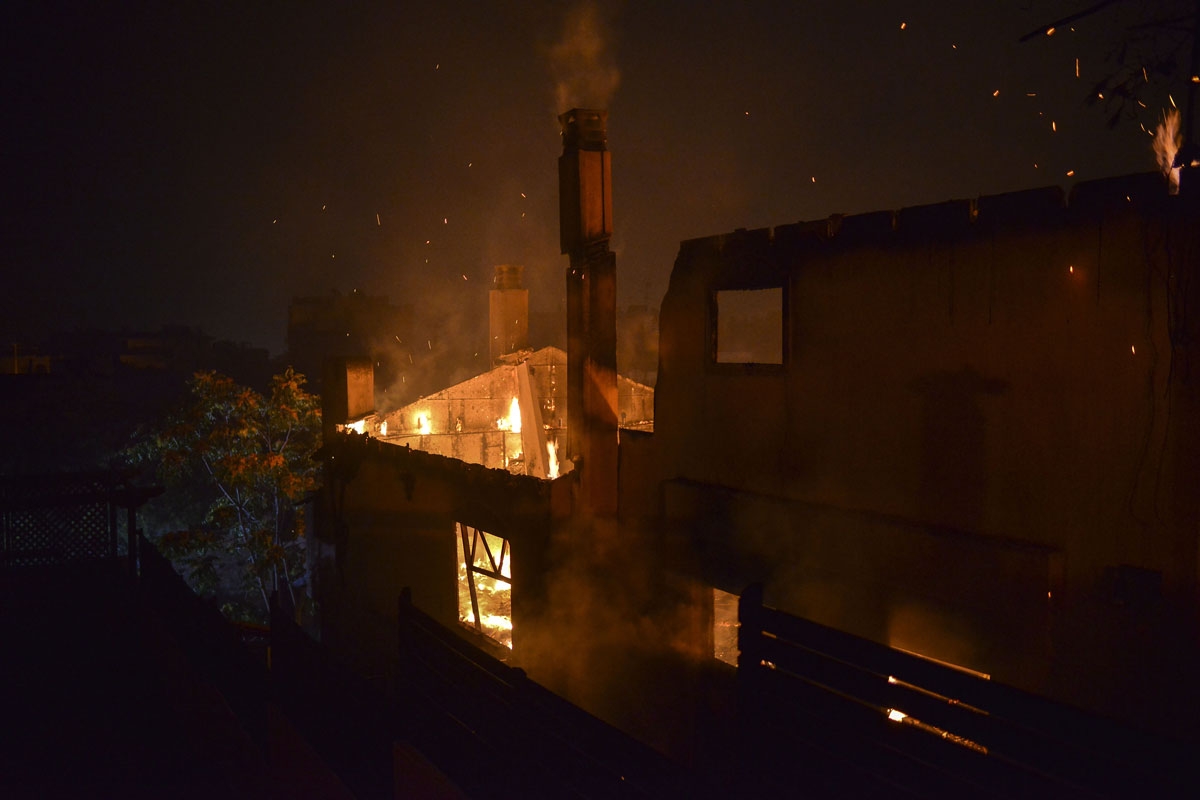 A house burns as a wildfire rages at the village of Mati, near Athens on July 23, 2018.