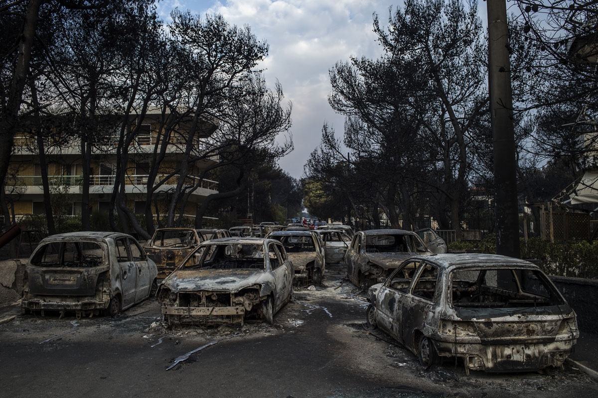 This photo taken on July 24, 2018 show cars burnt following a wildfire at the village of Mati, near Athens, on July 24, 2018.