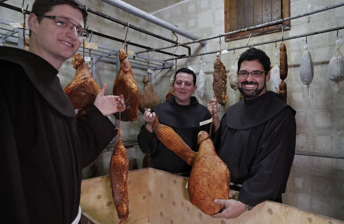 Franciscan friars show hams and sausages they produce for their consumption, at an underground basement at the Saint Saviour Convent, the Franciscan headquarters in the Old City of Jerusalem, on March 14, 2018.