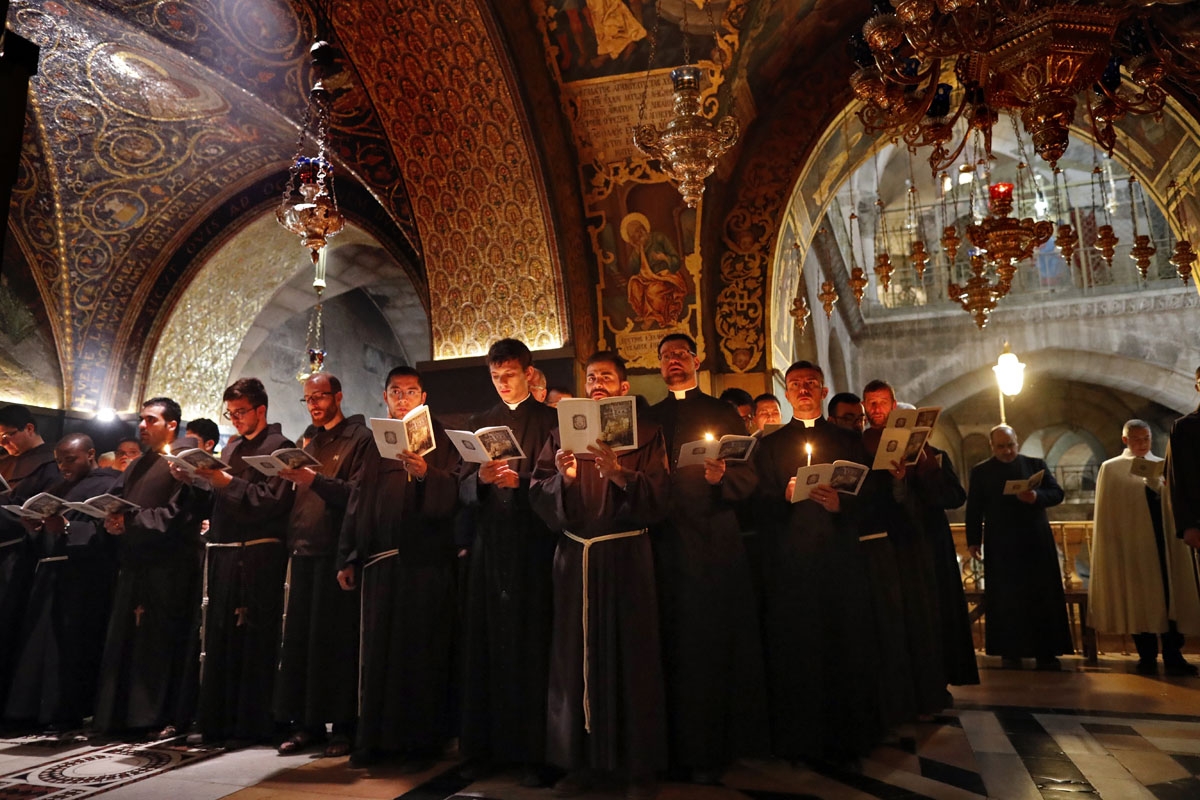 Franciscan friars pray and sing during the Lenten procession inside the Church of the Holy Sepulchre in the Old City of Jerusalem, on February 17, 2018.