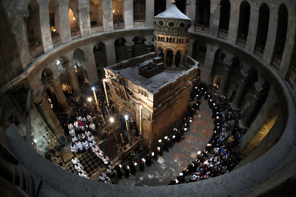 Franciscan friars pray and sing during the Lenten procession around the Tomb believed to the be site where Jesus Christ is buried in the Church of the Holy Sepulchre in the Old City of Jerusalem, on February 17, 2018.