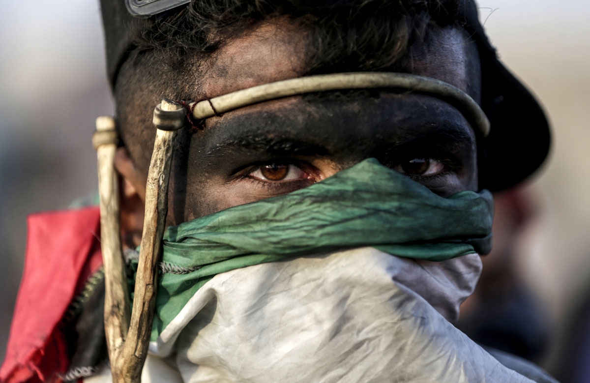 A Palestinian demonstrator looks on during clashes with Israeli forces along the border with the Gaza strip, east of Gaza City, on May 11, 2018, as Palestinians demonstrate for the right to return to their historic homeland in what is now Israel. - Over f