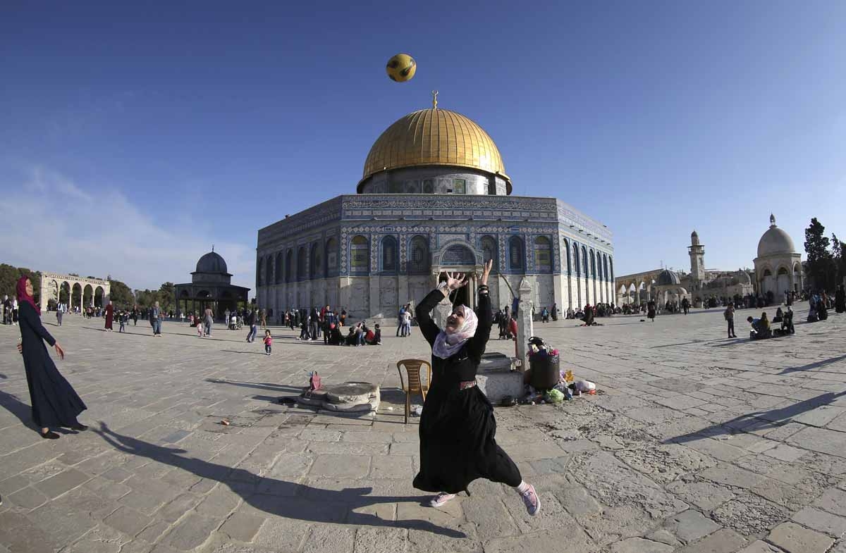 Playing football at the Al-Aqsa Mosque compound, with the Dome of the Rock in the background, April, 2017.