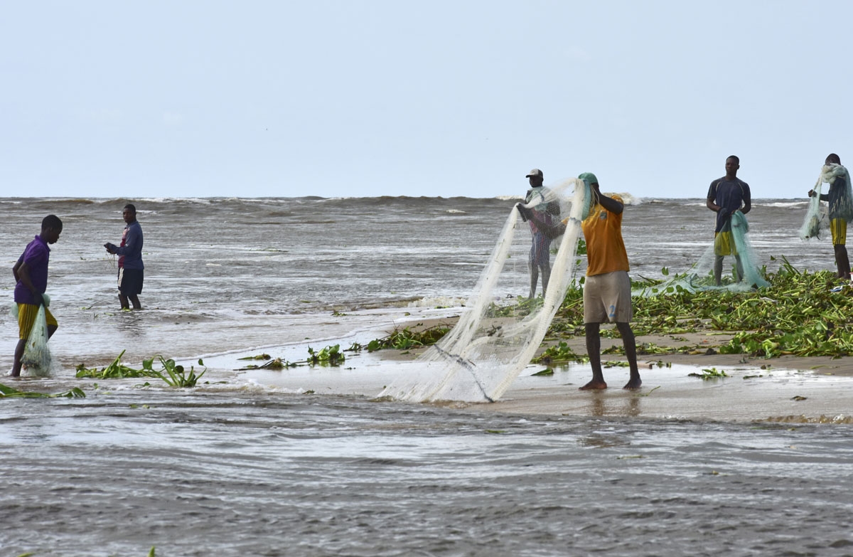 Fishermen cast their nets close to the shore of Grand Lahou on November 3, 2016.
