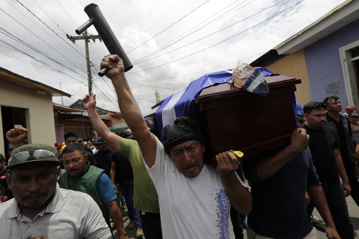 A friend of Jorge Carrion, 33, who was shot dead during protests against the government of President Daniel Ortega, carries a homemade mortar and shouts anti-government slogans during Carrion's funeral in the city of Masaya, 35 km from Managua on June 7,