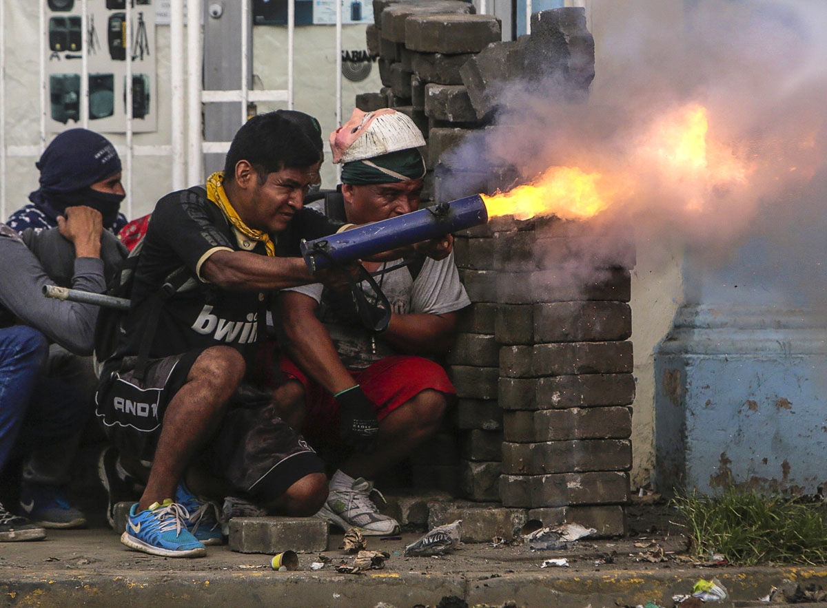 An anti-government demonstrator fires a home-made mortar during clashes with riot police at a barricade in the town of Masaya, 35 km from Managua on June 9, 2018.