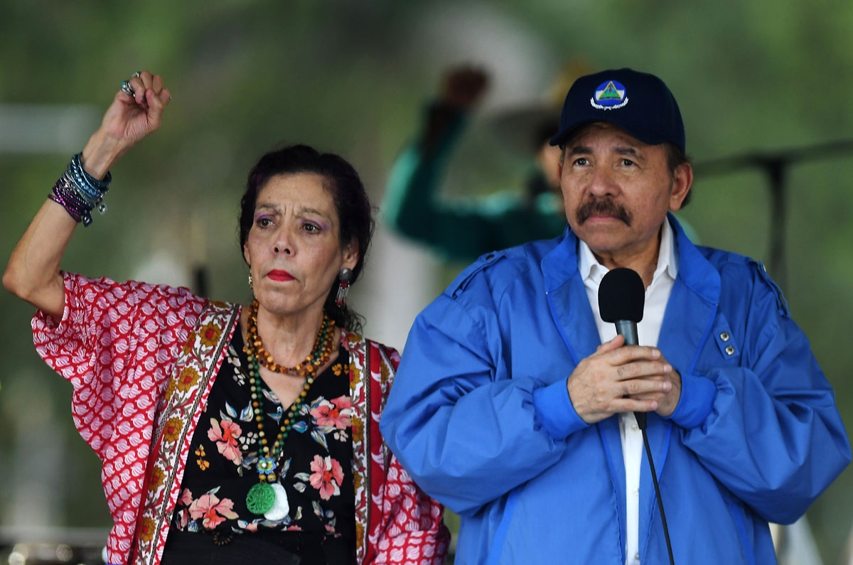 Nicaraguan President Daniel Ortega (R) and his wife, Vice President Rosario Murillo, cheer at supporters during the government-called Walk for Security and Peace in Managua on July 7, 2018.