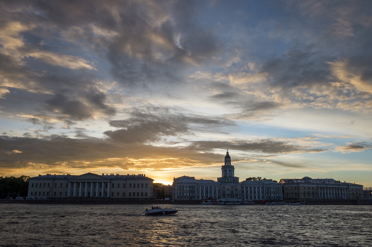 The sun sets behind the Kunstkamera at the embarkement of the Neva river in Saint Petersburg on June 21, 2017.