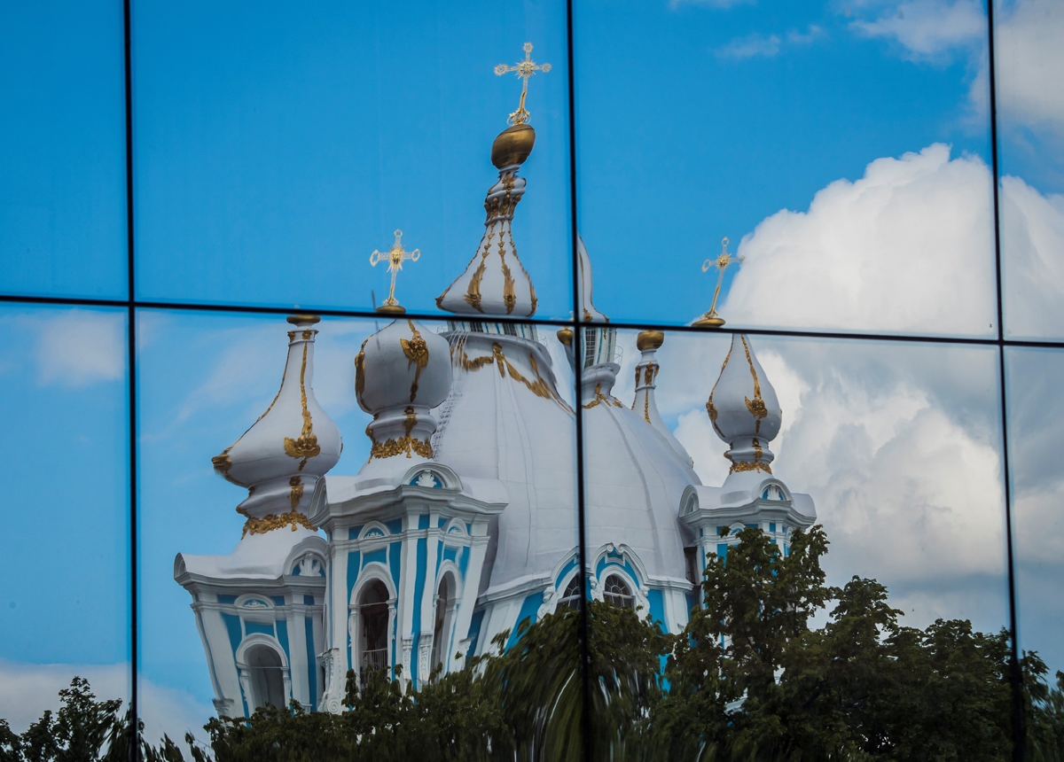 This photo taken on June 25, 2017 shows the domes of Smolny Orthodox Cathedral reflected on a nearby building in St.Petersburg.