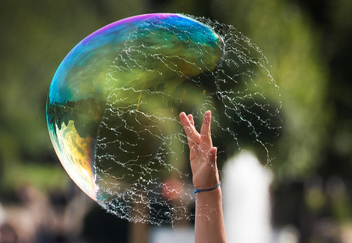 A boy bursts a soap-bubble at Gorky Park in Moscow on July 19, 2017.