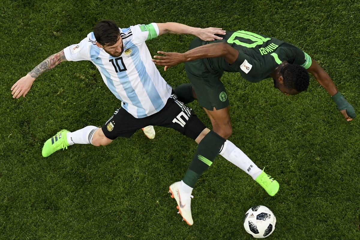 Argentina's forward Lionel Messi (L) and Nigeria's midfielder John Obi Mikel compete for the ball during the Russia 2018 World Cup Group D football match between Nigeria and Argentina at the Saint Petersburg Stadium in Saint Petersburg on June 26, 2018.