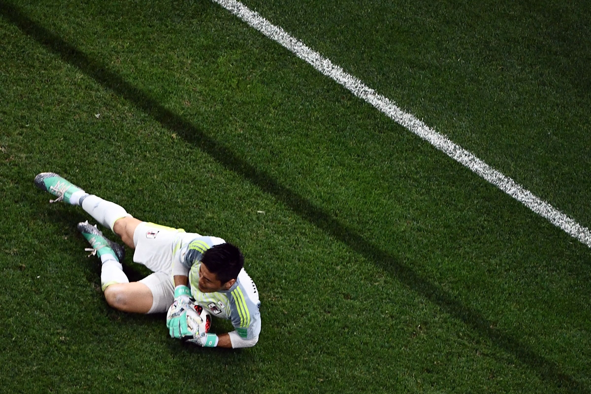 Japan's goalkeeper Eiji Kawashima stops the ball during the Russia 2018 World Cup round of 16 football match between Belgium and Japan at the Rostov Arena in Rostov-On-Don on July 2, 2018. / AFP