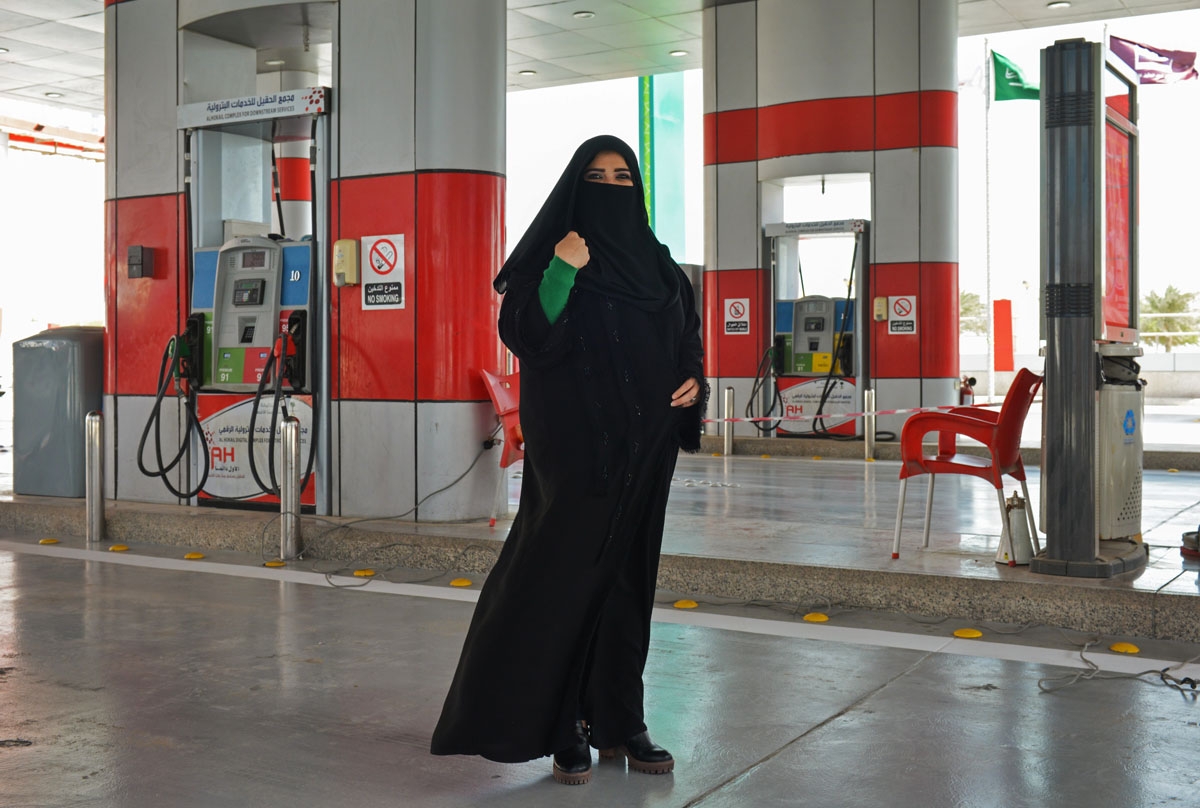 Murfa Bukhalid, a Saudi petrol station supervisor, poses for picture at the petrol station where she works in Khobar, some 400 kilometres east of Riyadh, on February 20, 2018. / AFP
