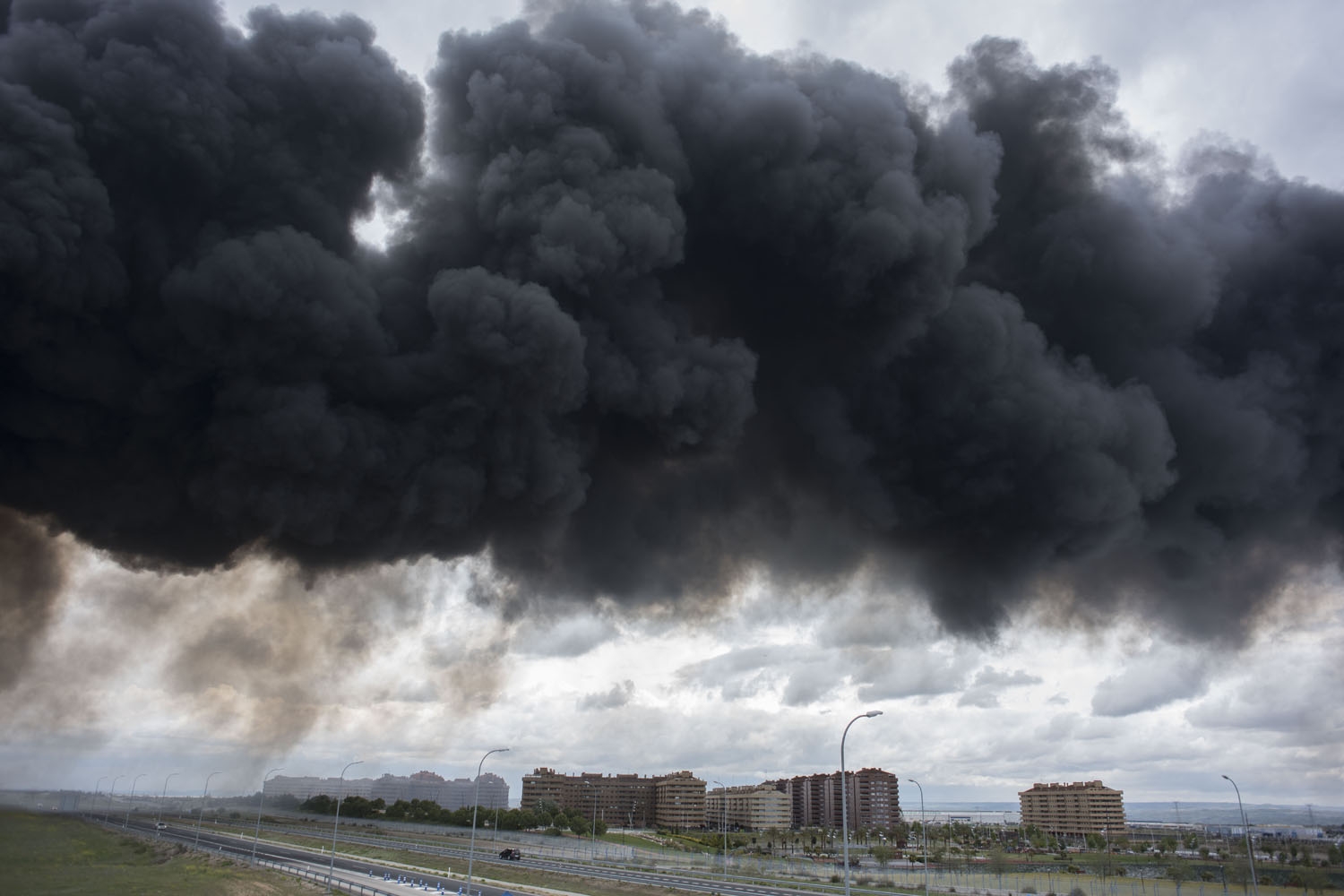 Black clouds of smoke are produced by tyres burning in an uncontrolled dump near the town of Sesena, after a fire brokeout early on May 13, 2016 Black clouds of smoke are produced by tyres burning in an uncontrolled dump near the town of Sesena, after a fire brokeout early on May 13, 2016