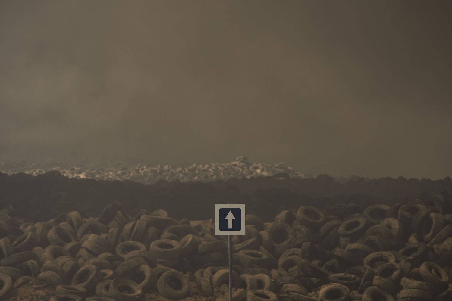 Tyres burn in an uncontrolled dump near the town of Sesena, after a fire brokeout early on May 13, 201 Tyres burn in an uncontrolled dump near the town of Sesena, after a fire brokeout early on May 13, 201