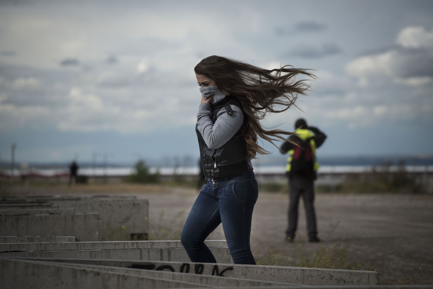 A woman covers her mouth in a residential area in Sesena affected by the toxic fumes A woman covers her mouth in a residential area in Sesena affected by the toxic fumes