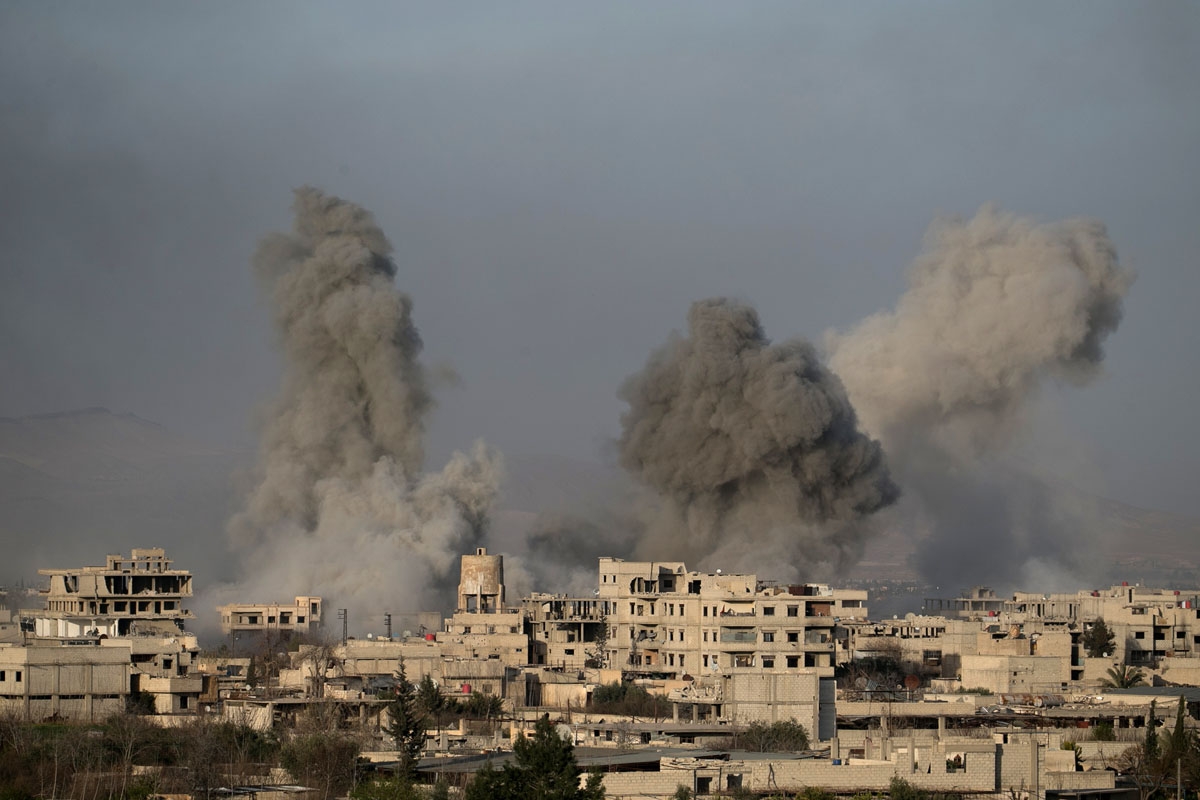 Smoke billows from buildings hit in Syrian government bombardments in Hammuriyeh, March 3, 2018.
