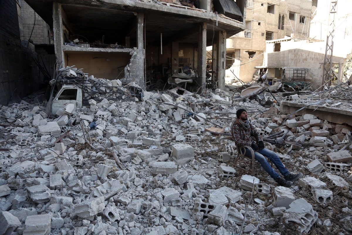 Ahmad Hamdan sits amid the destruction in Hammuriyeh on March 9, 2018.