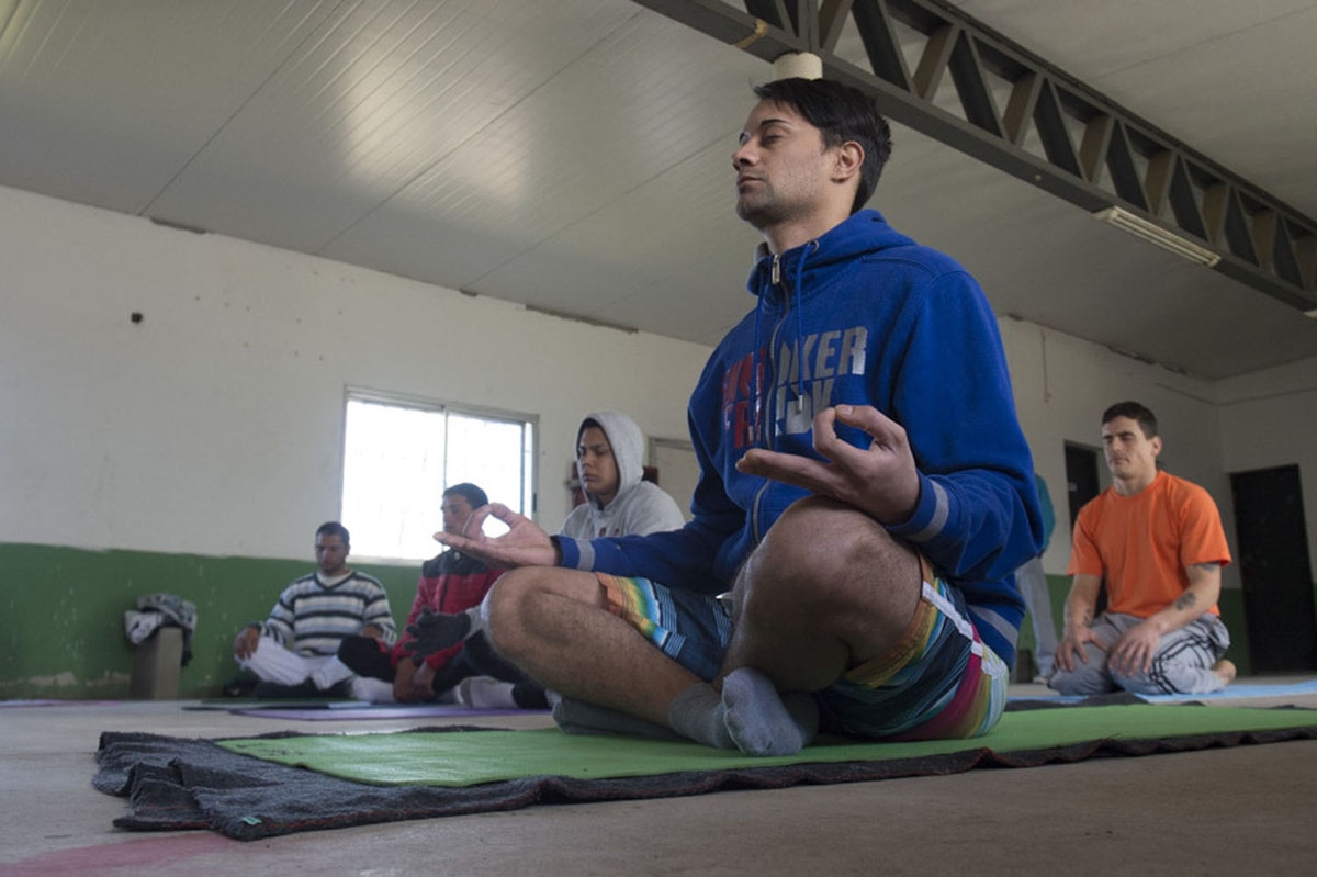 Inmate practice yoga at the Punta de Rieles prison in Montevideo on June 10, 2016. 