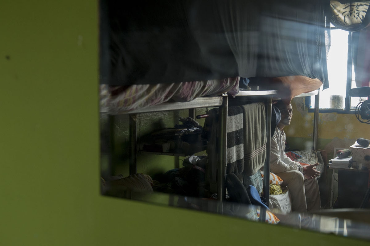 An inmate is seen reflected in a mirror inside his cell at the Punta de Rieles prison in Montevideo on May 05, 2016. 