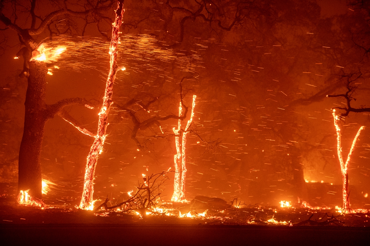 Embers fly as wind and flames from the Camp fire tear through Paradise, California on November 8, 2018. -
